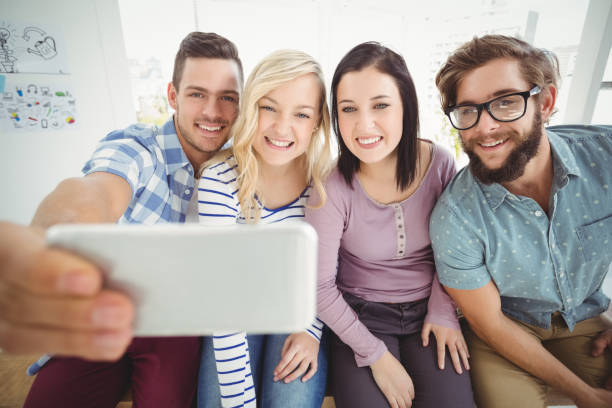 istock Smiling business people taking selfie 670625664