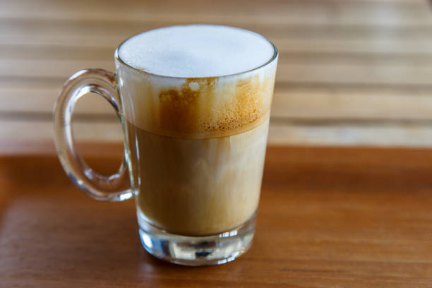 istock A cup of cappuccino on wooden table 670631514