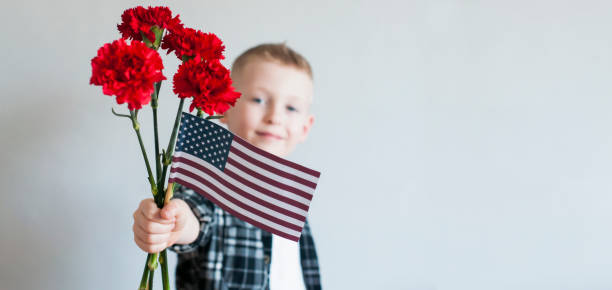 Kid with flowers and american flag stock photo