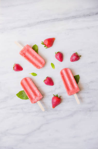 istock Above shot of Red Popsicles and Fruit on Marble 670644890