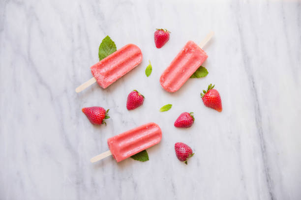 istock Above shot of Red Popsicles and Fruit on Marble 670644928