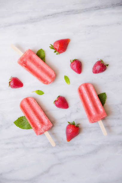 istock Above shot of Red Popsicles and Fruit on Marble 670644942