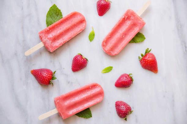 istock Above shot of Red Popsicles and Fruit on Marble 670644978