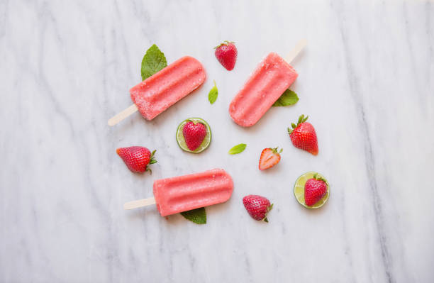 istock Above shot of Red Popsicles and Fruit on Marble 670645000