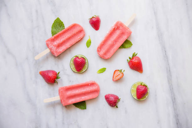 Above shot of Red Popsicles and Fruit on Marble