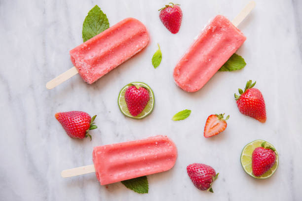 istock Above shot of Red Popsicles and Fruit on Marble 670645090