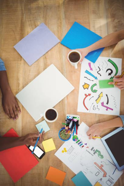 istock Directly above shot of cropped hands working at desk 670645138
