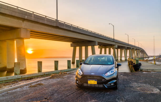 auto davanti a un ponte durante il tramonto - ford fiesta foto e immagini stock