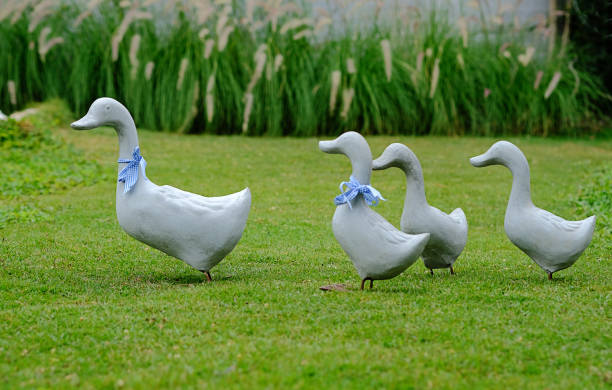 istock Duck family statue placed in a green park. 670652098