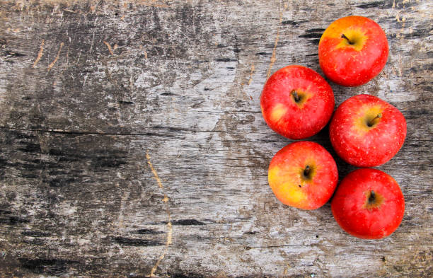 istock Red apples on wooden background 670654616