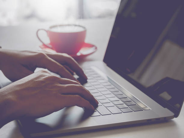 istock Man typing laptop and drink coffe in vintage tone background 670657806