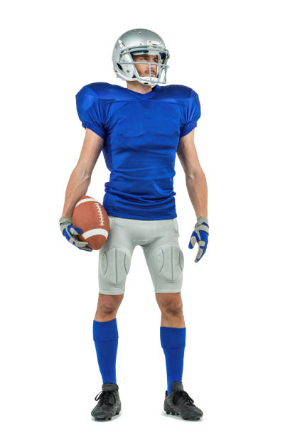 istock American football player looking away while holding ball 670661784