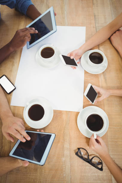 istock Overhead view of people using smartphones and digital tablet 670665122