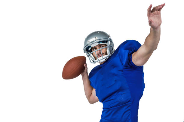 istock American football player looking away while throwing the ball 670671772