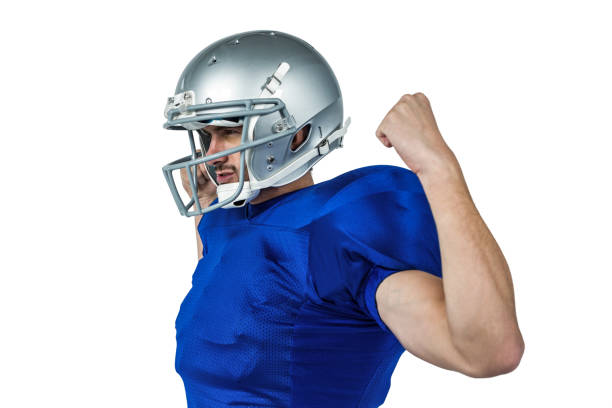 istock Confident American football player flexing muscles 670674590