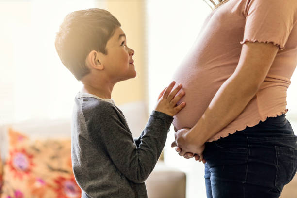 istock Boy Touching Pregnant Mother's Belly 670677854