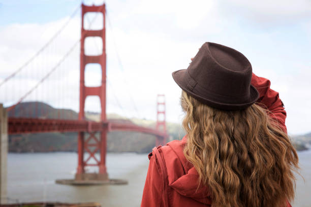 istock A girl standing by the Golden Gate Bridge 670678368