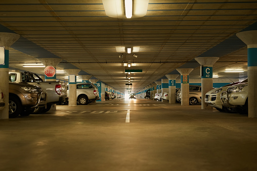 Shot of an underground parking garage full of cars