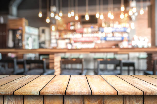 istock Empty wood top table with space for display product in Blurred cafe background. 670686406