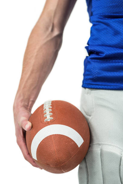 midsection of sports player holding ball - football player imagens e fotografias de stock