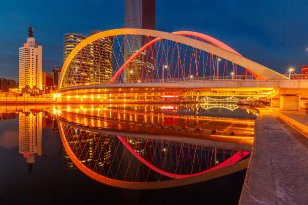 istock River And Modern Buildings Against Sky at night 670691630