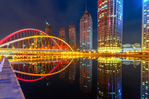 istock River And Modern Buildings Against Sky at night 670692340