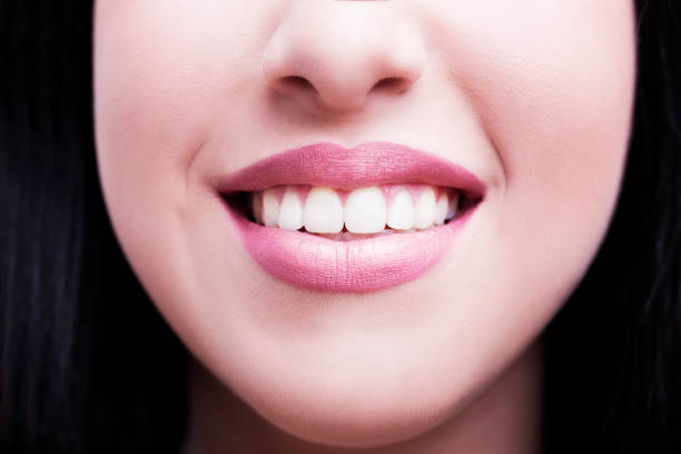 istock Close-up of smile with white healthy teeth 670692800