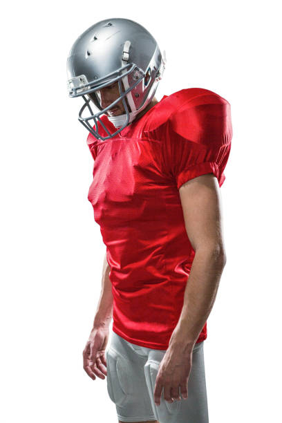 istock American football player in red jersey looking down 670692980
