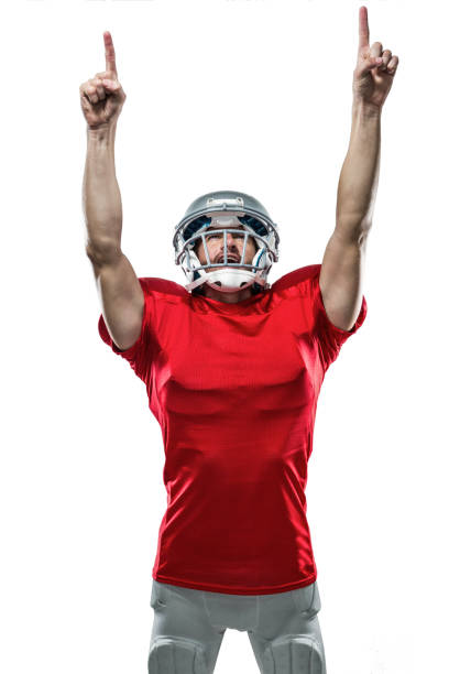istock American football player looking up with arms raised 670693036
