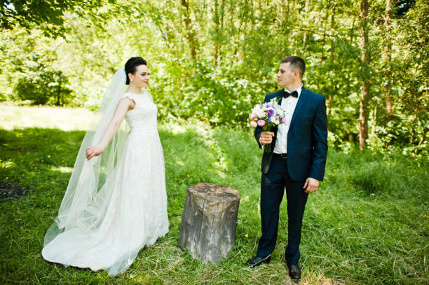istock Gorgeus wedding couple on green sunny forest 670696142