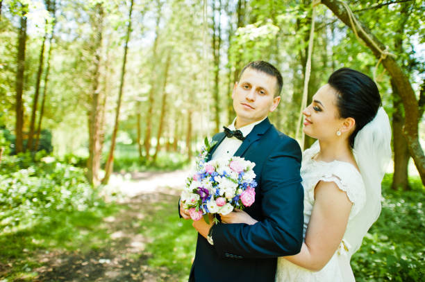 istock Gorgeus wedding couple on green sunny forest 670696360