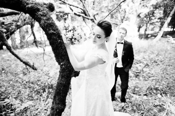 istock Gorgeus wedding couple on green sunny forest 670696374