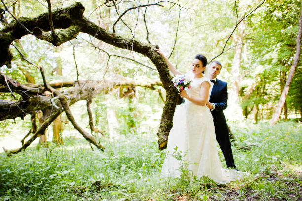 istock Gorgeus wedding couple on green sunny forest 670696420