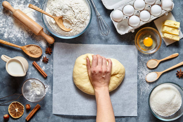 istock Baker chef mixing traditional dough bread, pizza or pie recipe ingridients 670701506