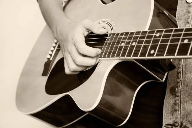 Photo of teenager playing guitar