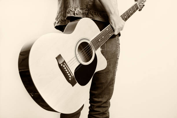 istock young artist holding a guitar 670702600