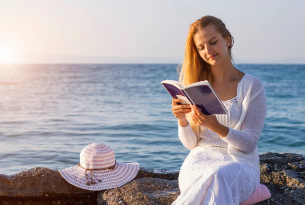 istock Reading a book on coastline with the perfect 670704864