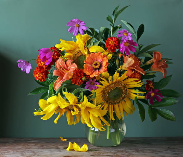 istock Still life with sunflowers on a green background. 670705910