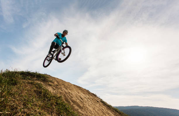 istock Below view of cyclist practicing straight air jump 670709716