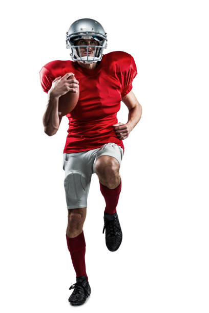 Full length of American football player in red jersey running Full length of American football player in red jersey running against white background american football player studio stock pictures, royalty-free photos & images