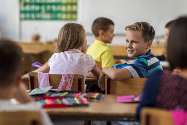 istock Smiling elementary student enjoying during the lecture in the classroom. 670713932