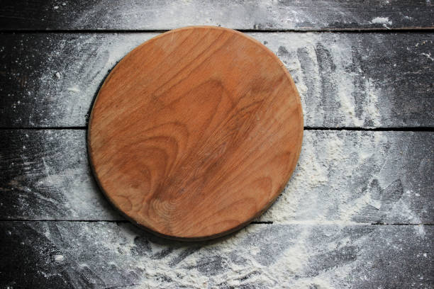 istock Cutting board with  flour on a wooden table 670726910
