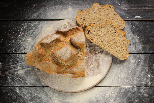 istock Sliced whole grain bread on a wooden table 670727358
