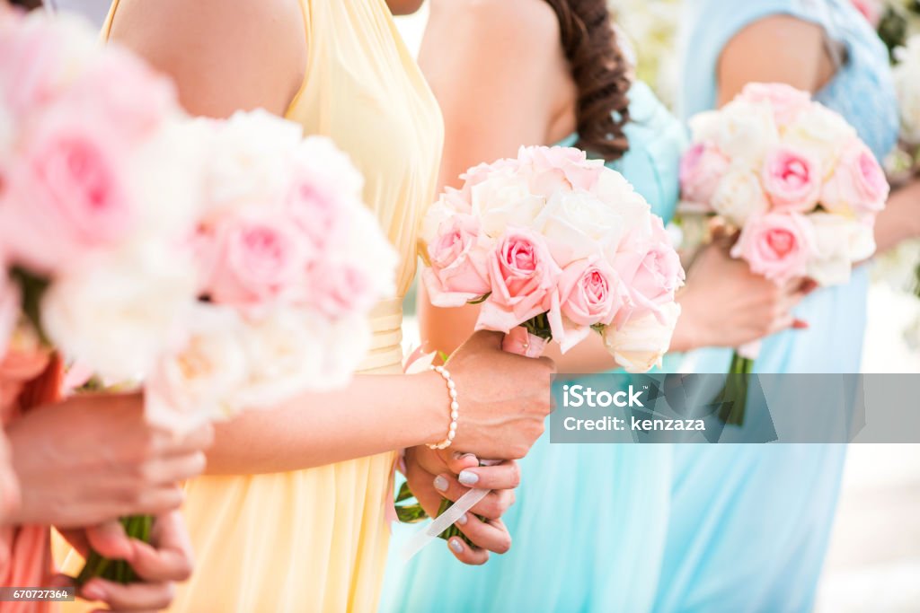 Bridesmaid holding a bouquet of roses at the wedding. Bridesmaid Stock Photo