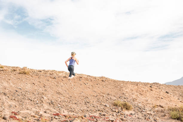 istock Active Lady on a Desert Run with Morning Sky in Background 670731304