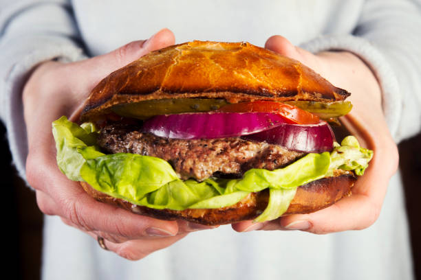istock Tasty burger in the hands 670737846