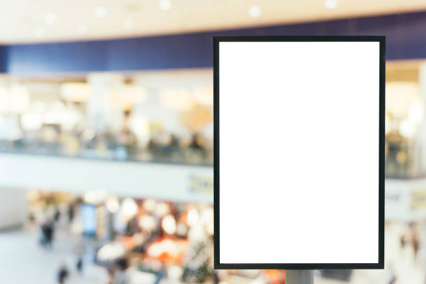 istock Blank mock up of vertical poster billboard sign with copy space for your text message or content in modern shopping mall. 670740276