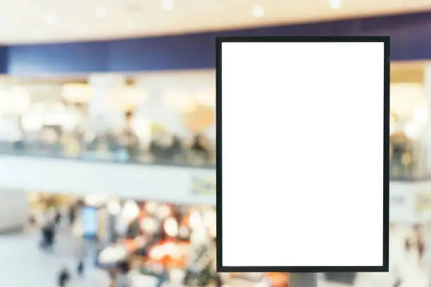 Blank mock up of vertical poster billboard sign with copy space for your text message or content in modern shopping mall.