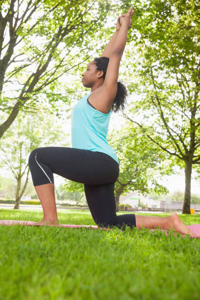 istock Young woman doing yoga on mat 670740456