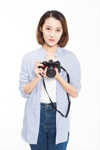 istock pretty girl holding hands SLR camera 670740578